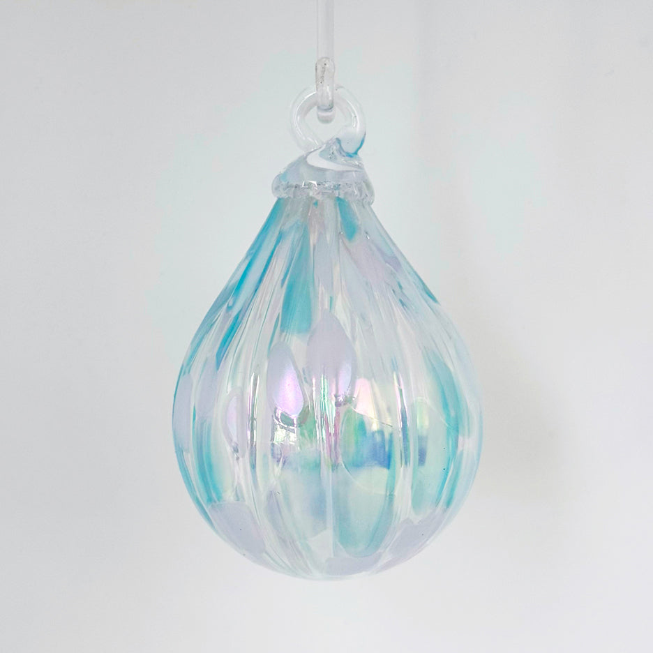 Iridescent glass ornament from the Lacey Collection, featuring a droplet shape and baby blue eyes finish.