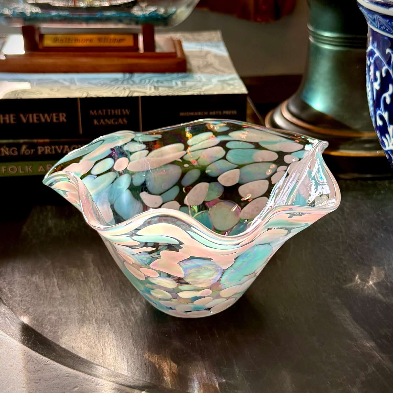 Baby Blue Eyes iridescent wave bowl featuring soft blue, lavender, and pearl colors under light.