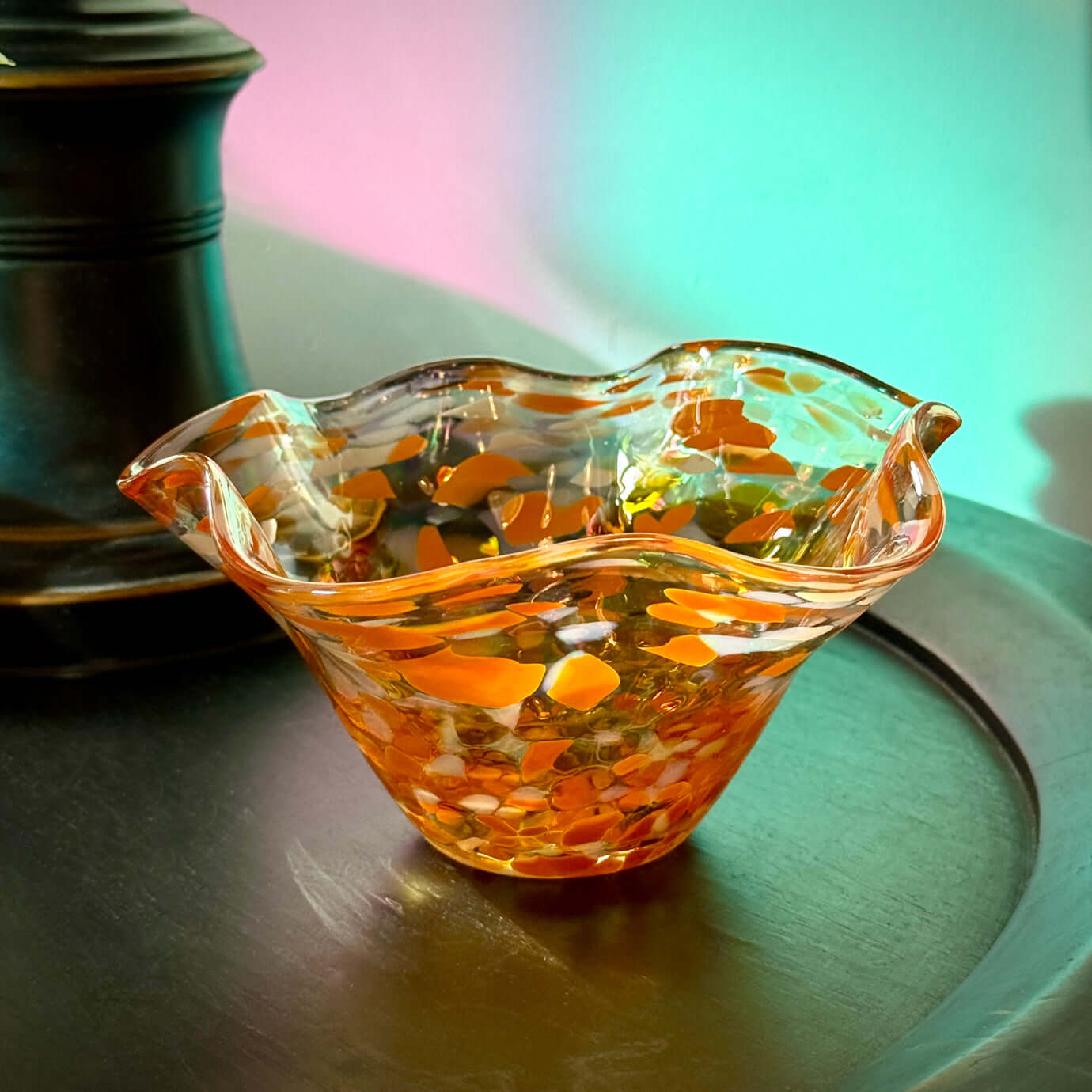 Handmade Salmonberry wave bowl featuring an iridescent finish with amber and orange hues.