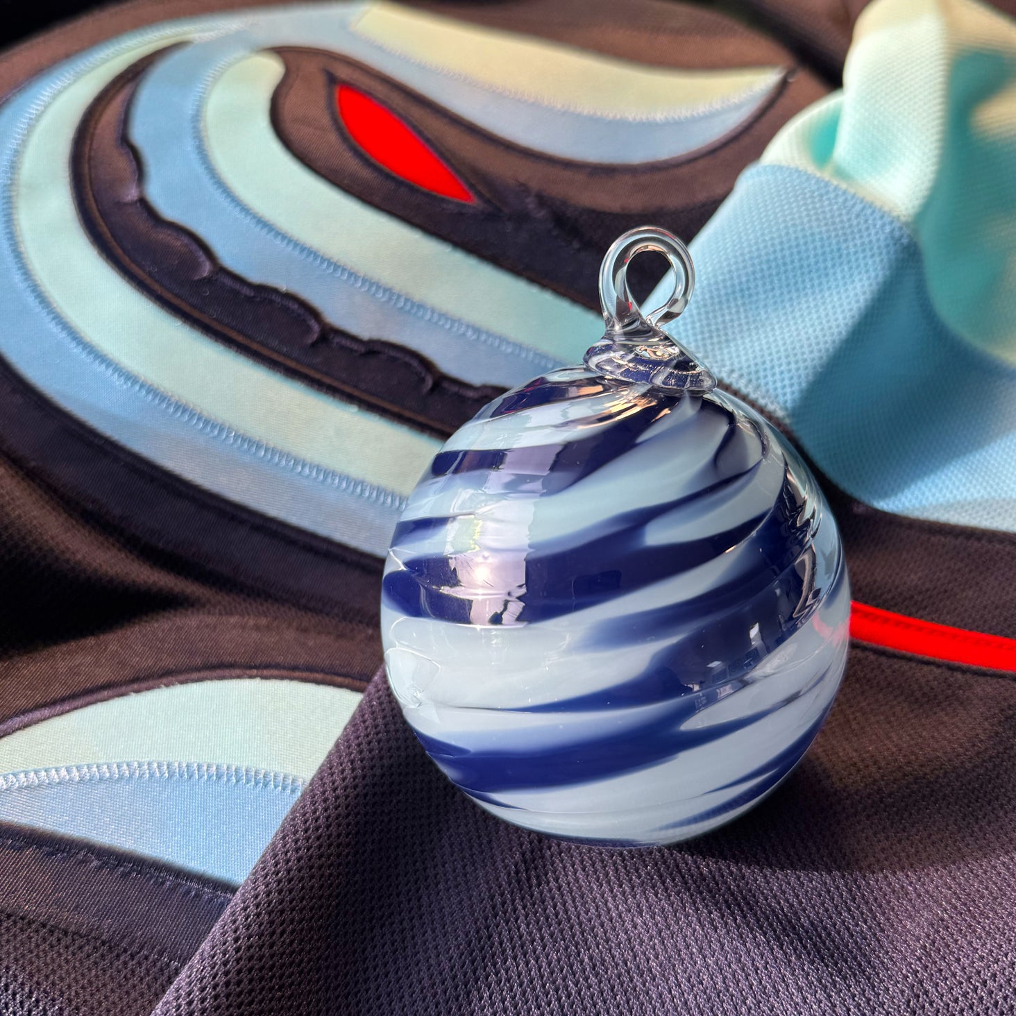 Glass blower crafts marbles and pendants